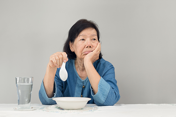 Elderly asian woman bored with food Senior Malnutrition