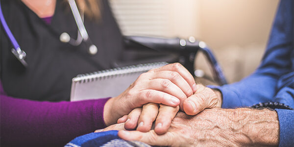 Doctor comforting senior adult