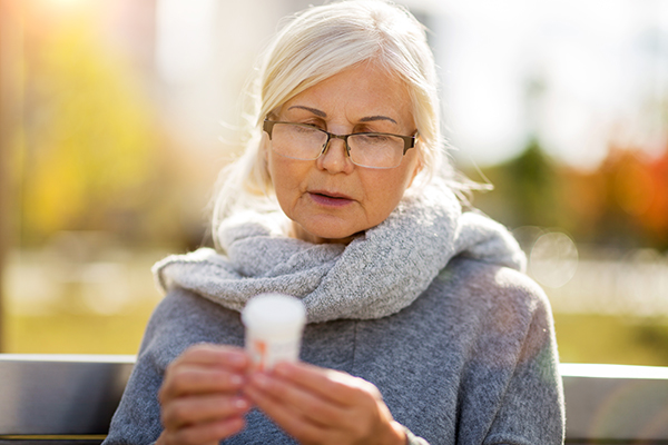 Senior woman checking label on medication Senior woman checking label on medication