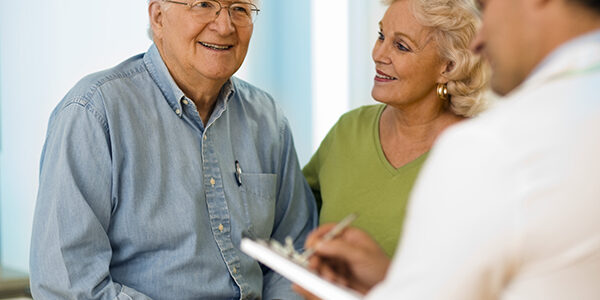 Senior couple talking with doctor. Senior couple talking with doctor.