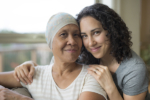 young adult female hugging her mother who has cancer