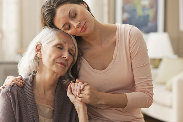 Portrait of tender mother daughter moment Daughter comforting senior mother