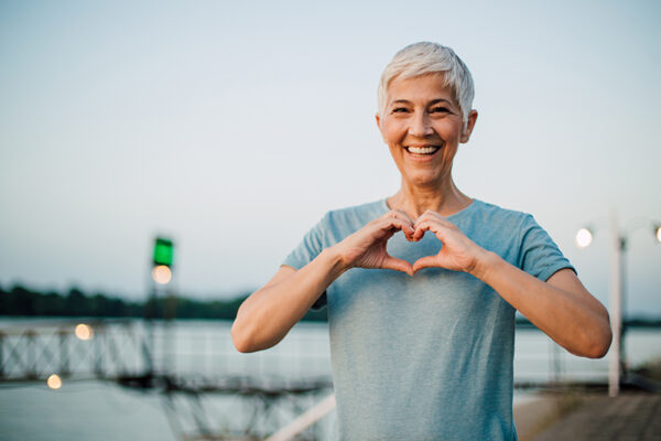 Active senior woman making a heart with her hands happy senior woman making a heart shape with her hands