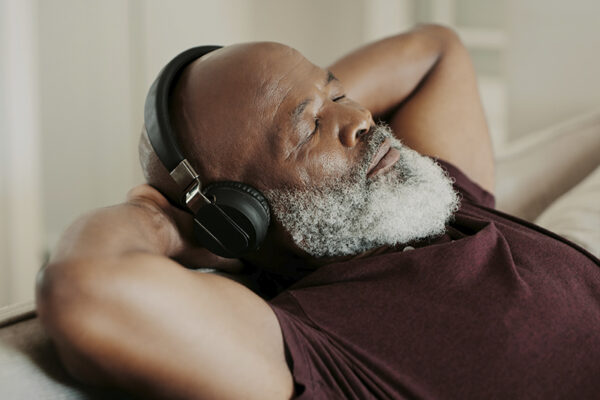 senior man relaxing and listening to headphones senior man relaxing and listening to headphones