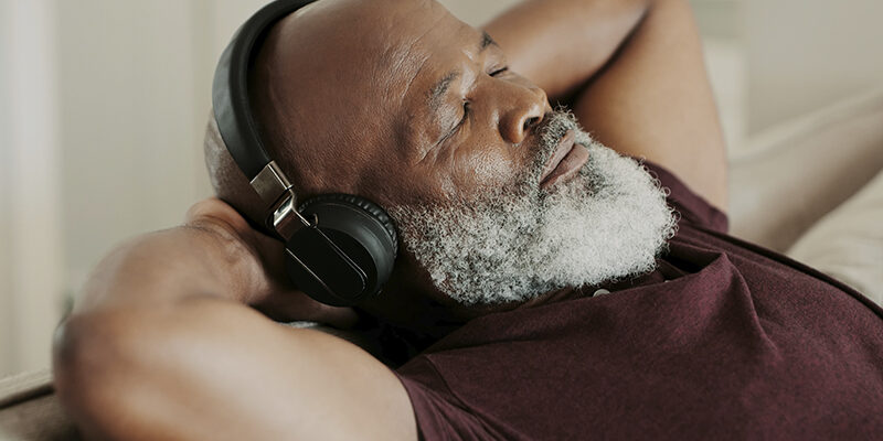 senior man relaxing and listening to headphones senior man relaxing and listening to headphones
