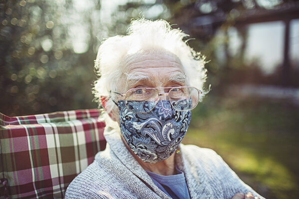 Friendly old senior wears a mask to protect against viruses and bacteria senior wears a mask to protect against viruses and bacteria