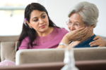 caregiver consoling senior woman