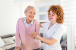senior woman getting assistance from caregiver