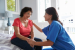 caregiver comforting senior woman