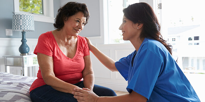caregiver comforting senior woman