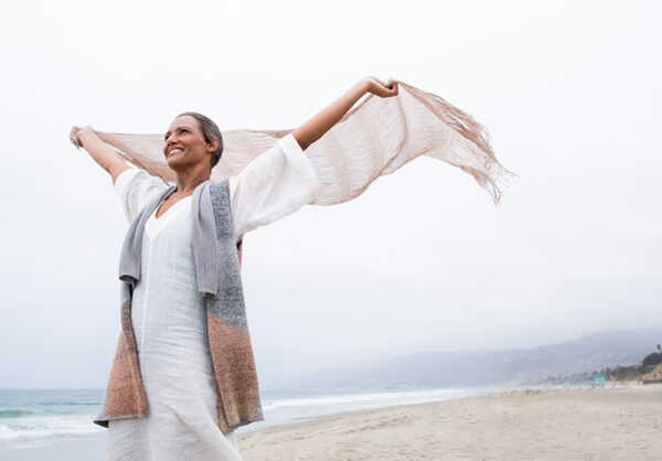 woman on beach in wind woman on beach in wind