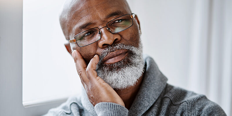 He’s thinking a few things through today handsome senior man looking thoughtful while sitting in his home
