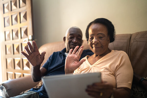 Senior couple on a video calling using a digital tablet at home Senior couple on a video calling using a digital tablet at home