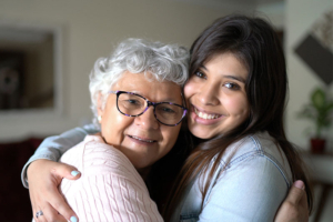 senior with dementia hugging caregiver