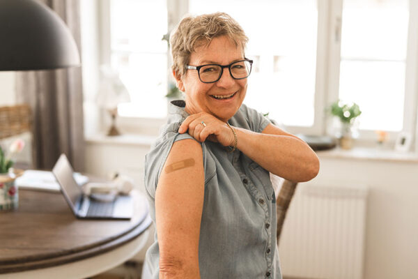 senior-woman-showing-bandage-on-arm senior-woman-showing-bandage-on-arm