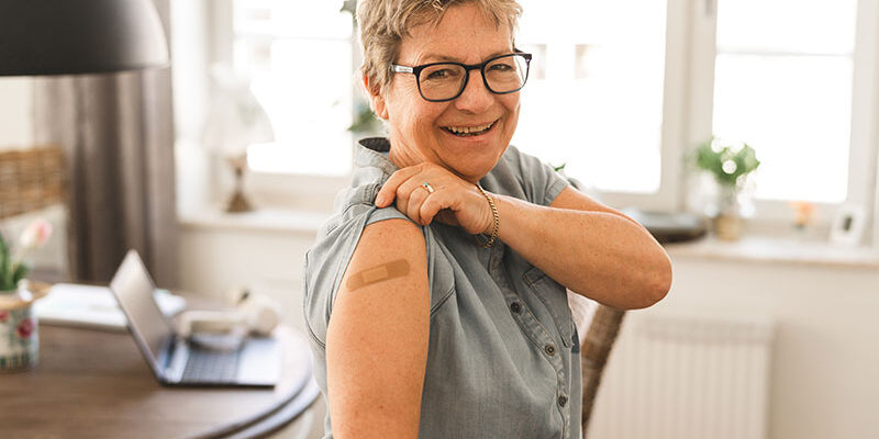 senior-woman-showing-bandage-on-arm senior-woman-showing-bandage-on-arm