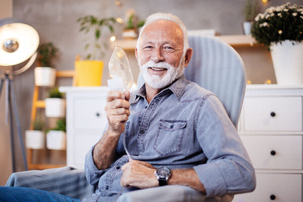 happy-senior-man-holding-oxygen-mask-with-copd happy-senior-man-holding-oxygen-mask-with-copd