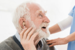 happy senior man wearing hearing aid