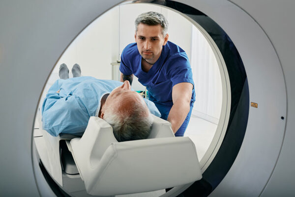 senior-man-getting-Cat-scan-with-technician medical tests for older adults