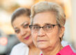 A senior stares into the camera after being asked, “What do family caregivers need?”
