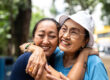 A daughter of a senior hugs the senior after learning tools for effective communication with seniors with dementia.